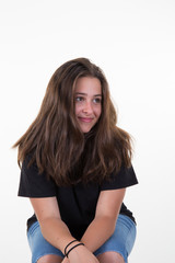 Young teenage girl sit on chair isolated on white background