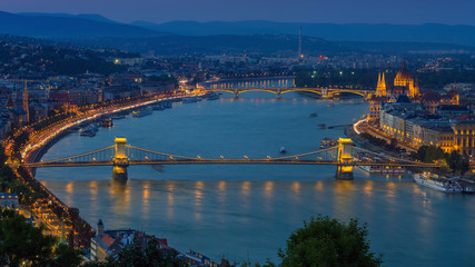 Budapest, Hungary - Panoramic skyline view at blue hour of the famous Szechenyi Chain Bridge, Margaret Bridge, Margaret Island and Parliament of Hungary with Buda Hills at background with colorful sky