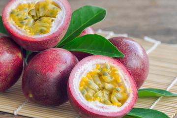 Close up fresh passion fruit stack on wood table in side view. Passion fruit is popular tropical...