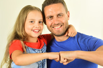 Schoolgirl and dad beat fists in agreement. Childhood and family