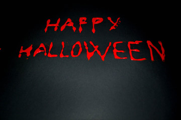 Happy halloween red words on black background. Happy Halloween text with paint or spray. Halloween inscription. Banner.