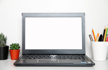 Fototapeta premium studio workplace with blank screen laptop and supplies with copy space for your text.