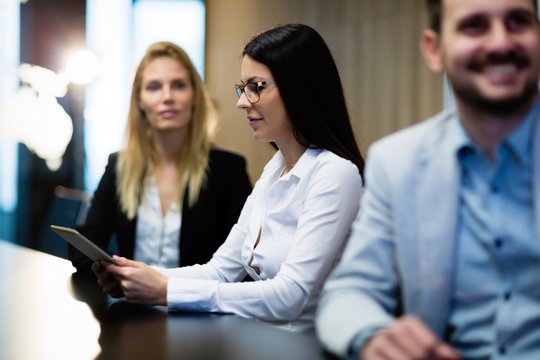 Young attractive businesswoman using tablet on meeting