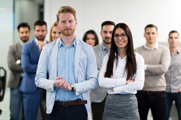 Successful team of young perspective businesspeople in office