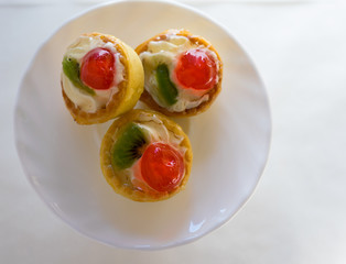 Mini tarts with fruits, top view, white background 
