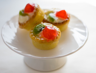Mini tarts with fruits, front view, white background 