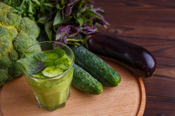 Diet concept, healthy lifestyle, low calorie detox and dietary food. Blended green smoothie with ingredients on wooden table