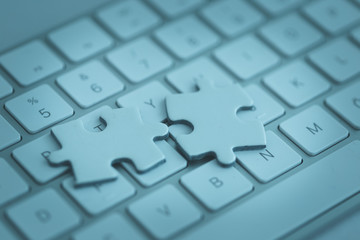 KEYBOARD WITH A PIECE OF A PUZZLE CONCEPT