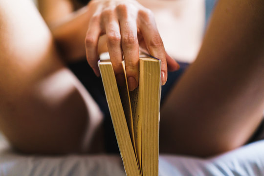 Seductive woman posing with book