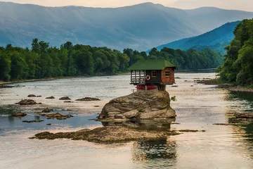Zelfklevend Fotobehang Lonely house on the river Drina in Bajina Basta, Serbia © nedomacki