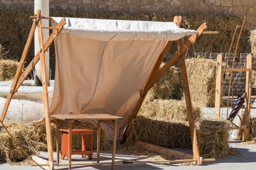 Traditional Medieval encampment setup for archery practice feathered arrows and bow front of...