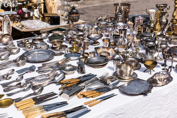 Vintage silver cutlery and tableware at a garage sale at the flea market in Paris. France