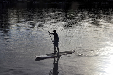 Teenage Boy on Paddleboard at Dusk