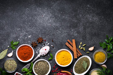Set of Various spices and herbs on black slate table. 