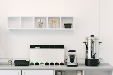 Modern minimalist design of the kitchen. Household appliances on the kitchen table in the office....