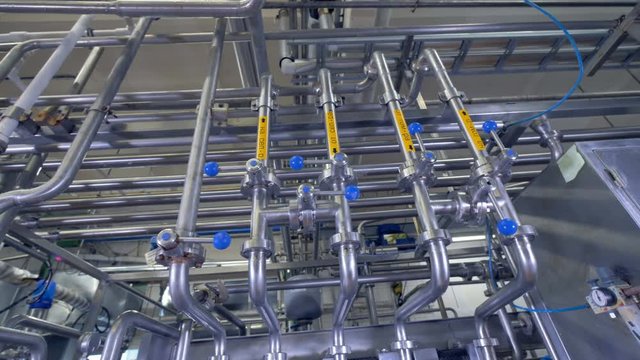 Milk and water pipelines at a dairy factory. 