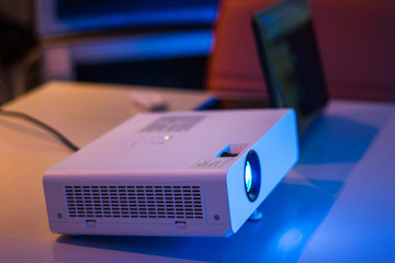 projector connected to Laptop for presentation on white table in a meeting room  