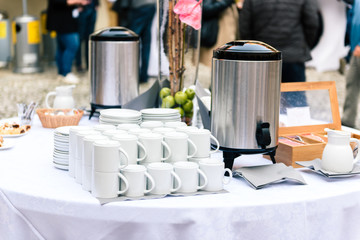 Coffee, cups on catering table at conference or wedding banquet.