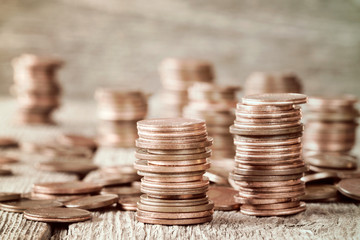 Coins stacked on wooden background