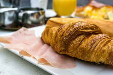 Breakfast with coffee and croissants on table