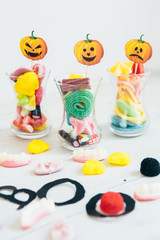 Halloween party decoration. Candies in glass  