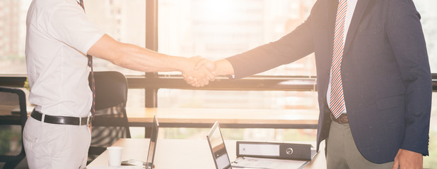 handshake of business People Colleagues Teamwork Meeting .Hold hand and shake hand in office city...