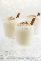 traditional Christmas eggnog with whipped cream and cinnamon