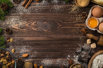 Christmas food background. Baking Ingredients ( fluor, eggs, butter, nuts, sugar, dried fruits) on wooden table. top view. Copy space