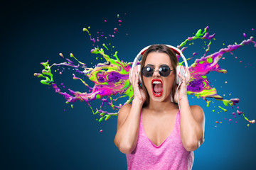 Happy young woman listening music in headphones