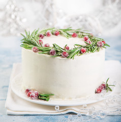 Christmas cake decorated with rosemary and sugar cranberries