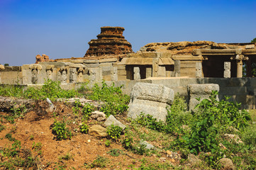 Tourist Indian landmark, Ancient ruins in Hampi. Beautiful nature scenery with bright blue sky and strange landscape with large rocks, Hampi, India