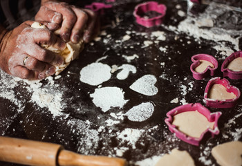 The man cook prepares flour products and meal-free flour on a glass table. Beautiful conceptual photo