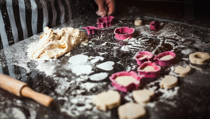 The man cook prepares flour products and meal-free flour on a glass table. Beautiful conceptual photo