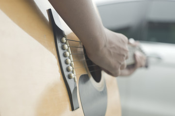 Boy playing an acoustic guitar