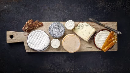 Gardinen French cheese platter with Spanish dulce de membrillo as top view on a wooden board © HLPhoto