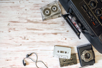 cassette player, cassette recorder and audio tape on a wooden background