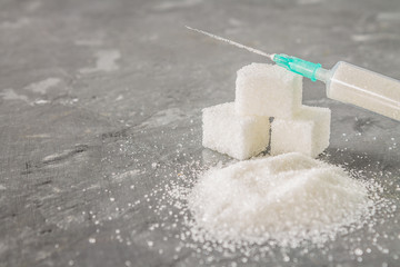 Sugar in a syringe. Conceptual depiction of dependence on the sweet. Sugar is a drug. Injection of sweets.