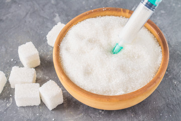 Sugar in a syringe. Conceptual depiction of dependence on the sweet. Sugar is a drug. Injection of sweets.