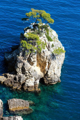 Rock near beach Cala di Porto Greco, Italy.