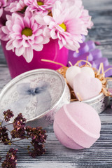 SPA composition with pink bath bombs, daisy flowers
