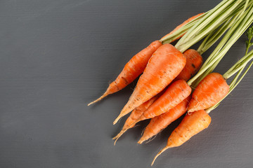 Fresh carrots on grey background