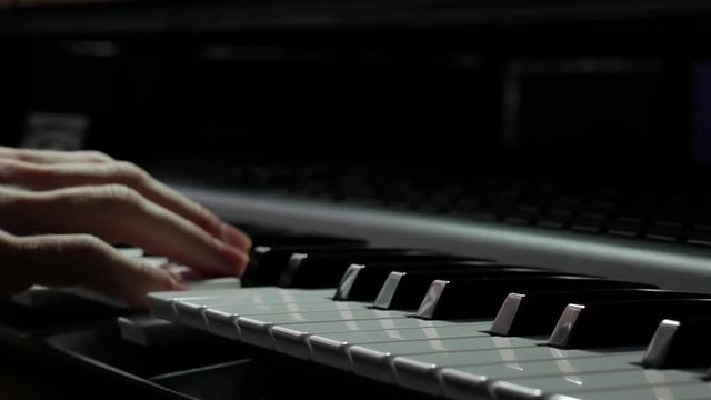 Playing piano synthesizer in a studio closeup stock video 2160p 