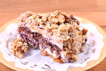 portion of white and brown chocolate walnut cake with walnuts