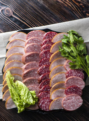 Sliced sausage, ham with parsley.