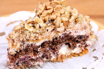 portion of white and brown chocolate walnut cake with walnuts