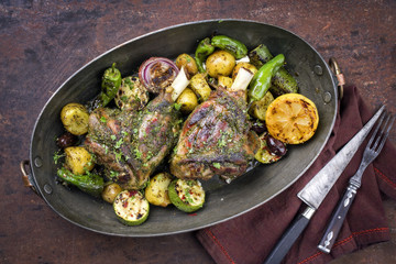Barbecue leg of lamb with vegetable and potatoes as top view in a casserole