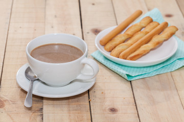 salted bread stick and cup of coffee