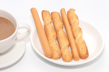 salted bread stick and cup of coffee