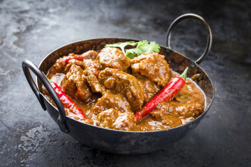 Traditional Indian curry lamb masala as close-up in a Korai - obrazy, fototapety, plakaty