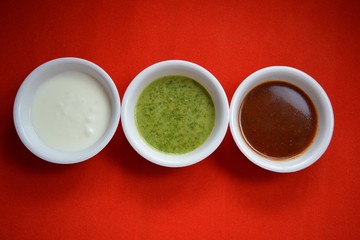 Coriander chutney and tamarind chutney with curd.